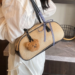 Handmade woven shoulder bag with black trim, blue checkered ribbon and bear pendant