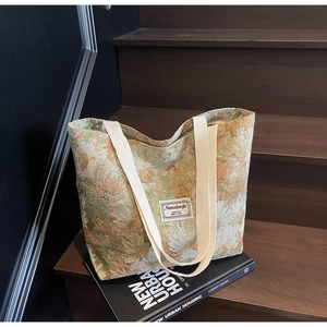 Floral canvas tote bag with retro pattern placed on wooden stairs in a lifestyle setting