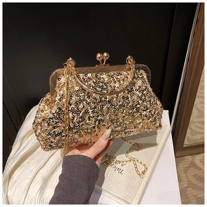 Macro view of luxury gold sequin evening clutch bag with metallic frame and ball lock