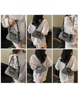 Detailed model views of a black underarm bag with bow accents and chain strap
