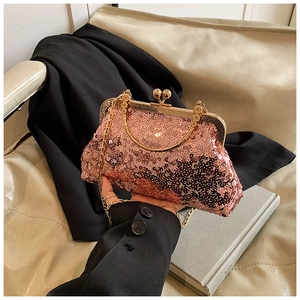 Detail of rose gold sequin evening bag with metal handle and beaded clasp closure