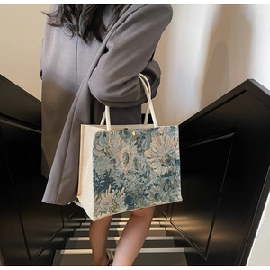 Detailed close-up of vintage floral jacquard embroidery on cotton linen tote bag side