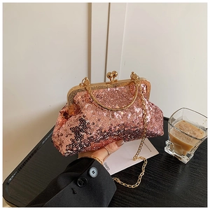 Detail of rose gold sequin evening bag with kiss-lock closure and metal handle