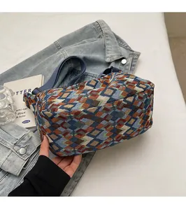 Detail of bohemian geometric woven tote bag with colorful diamond jacquard patterns