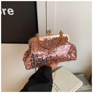Detailed view of rose gold sequin evening bag with metal handle and kiss-lock closure