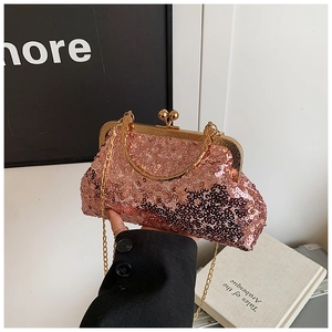 Detail of rose gold sequin evening clutch with gold metal frame and bead clasp