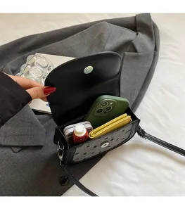 Interior view showing the large capacity of the grey polka dot shoulder bag for daily essentials