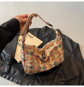 Detail of bohemian woven canvas tote bag with colorful geometric patterns and strap