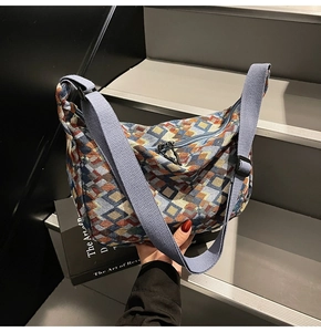 Detailed view of woven jacquard tote bag with geometric pattern and wide canvas strap