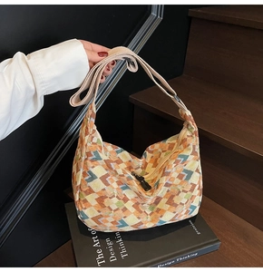 Detail of bohemian hobo bag with geometric pixel pattern and adjustable strap