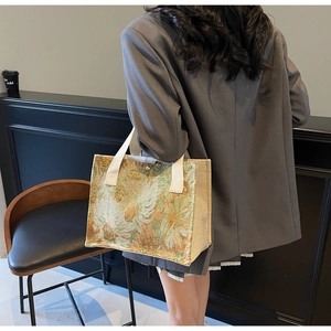 Close-up of floral tapestry embroidery on cotton linen tote bag with sturdy woven handles