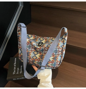 Detail of bohemian tote showing colorful geometric tapestry and adjustable blue strap