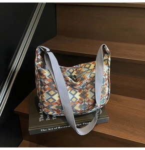 Close-up of bohemian tote bag featuring colorful geometric jacquard weave and wide strap