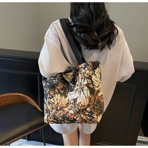 Detail of vintage sunflower jacquard tote bag with wide black canvas shoulder straps