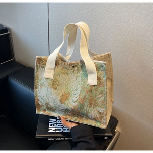 Detail view of cotton linen floral tote bag with embroidery texture and top snap closure
