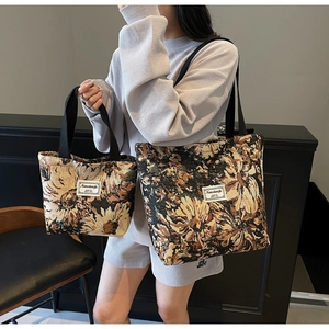 Detail of vintage floral jacquard tote bags with woven straps and logo patch