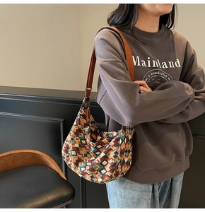 Detail view of jacquard geometric tote bag featuring vintage pattern and orange strap
