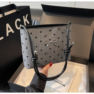 Polka dot canvas bucket bag with silver bow detail presented in a premium gift box
