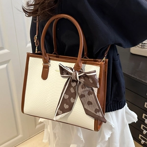 White snakeskin tote bag with brown trim and heart print scarf for stylish women
