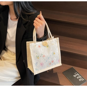 Chic cream canvas tote bag with floral lace overlay and thick woven rope handle detail