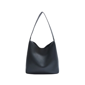 Large black minimalist tote bag with smooth leather finish and spacious interior for daily use