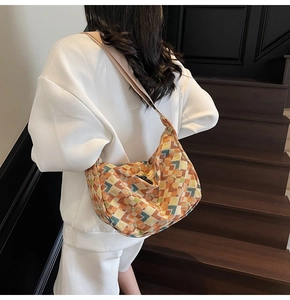 Detail of bohemian geometric canvas hobo bag with colorful mosaic pattern and wide strap