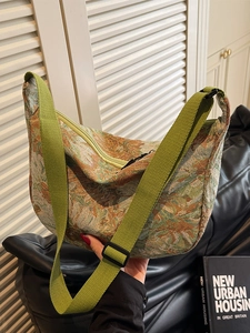 Floral jacquard half-moon tote bag with adjustable green strap for campus commuting