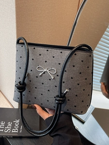 Elegant grey canvas tote with black heart patterns and silver bow accent detail