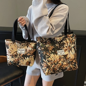 Vintage floral canvas tote bag in two sizes with black handles and woven logo patch