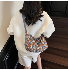 Detail of bohemian geometric pattern canvas tote bag on wide strap with model