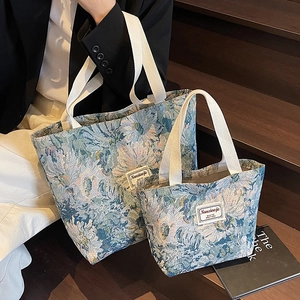 Floral canvas tote bags in two sizes featuring retro blue-green patterns and white handles