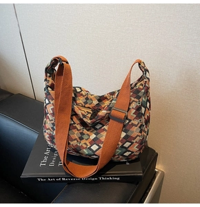 Detail of bohemian canvas tote with geometric pattern and adjustable orange shoulder strap