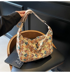 Detail of colorful geometric canvas hobo bag with adjustable wide fabric shoulder strap