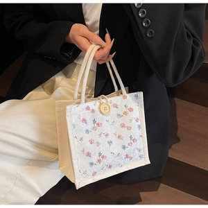 Floral canvas tote bag with thick rope handles and vintage wood button closure