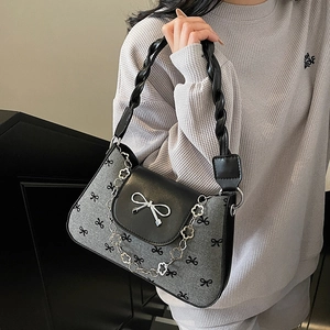 Fashionable grey underarm bag with black bow prints and twisted rope handle for women