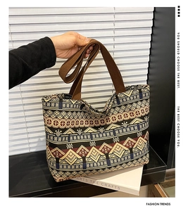 Close-up of geometric ethnic pattern on canvas tote bag with wide brown shoulder strap