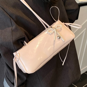 Pink glossy faux leather underarm bag with pearl bow and silver heart pendant