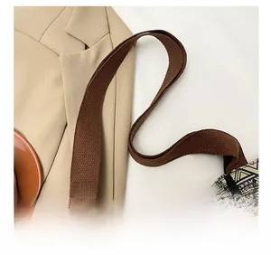 Detail view of ethnic patterned tote with wide woven canvas shoulder strap