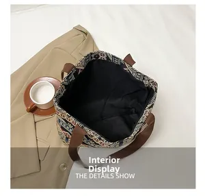 Spacious interior of ethnic tote bag with geometric patterns and brown straps