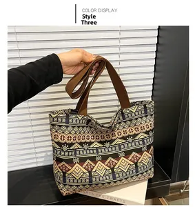 Detailed close-up of ethnic geometric pattern and wide handle on canvas tote bag