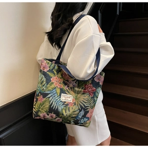Detail of floral brocade tote bag with palm leaves and blue butterfly patterns