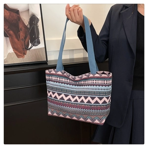 Ethnic style canvas tote bag with colorful geometric patterns and blue shoulder strap