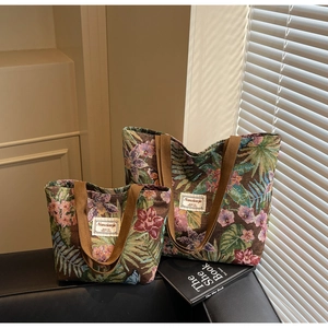 Close-up of floral tapestry jacquard tote bags in two sizes with woven handles