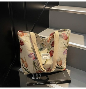 Close-up of vintage floral tote bag with embroidered tulips on beige woven fabric