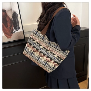 Ethnic style canvas tote bag with geometric patterns and brown wide shoulder strap