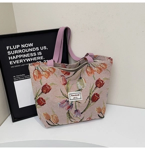 Close-up of jacquard tote bag with tulip floral patterns and light purple handles