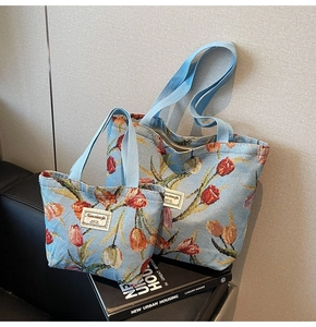 Close-up of high-quality tulip jacquard tote bag set on elegant leather sofa