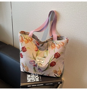 Detail of tulip jacquard tote bag showing woven texture and purple fabric handle