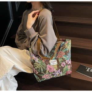 Detail of vintage floral jacquard tote bag featuring tropical palm leaf embroidery