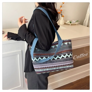 Close-up of bohemian tribal pattern tote bag with woven shoulder strap in a cafe